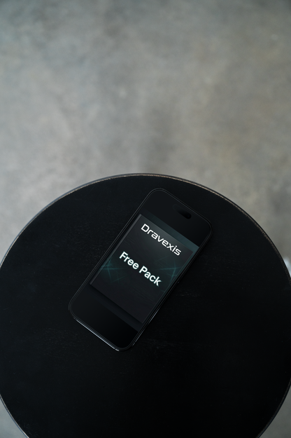 Phone with Dravexis Free Pack app on a black surface
