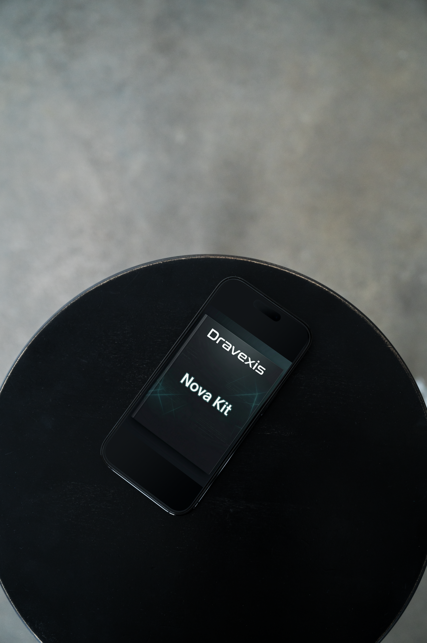 Black phone with 'Dravexis Nova Kit' on a dark surface